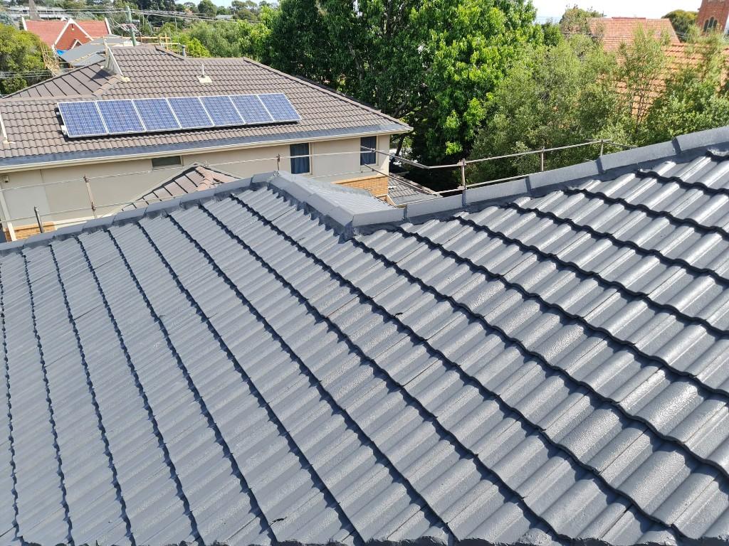 Freshly restored grey concrete tile roof on a Melbourne home by IronPeak Roofing